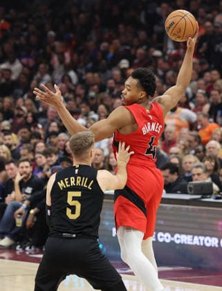 Toronto Raptors Scottie Barnes (4) grabs a pass over Cleveland Cavaliers Sam Merrill (5) in the third quarter in Cleveland, Ohio Sunday May 3, 2026. The Cavaliers defeated the Raptors 114-102 to advance to play the Detroit Pistons.  CLE20260503120 AARONxJOSEFCZYK
