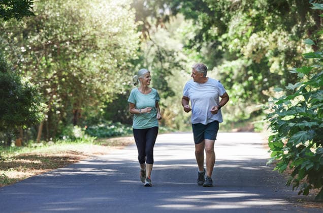 Senior couple, exercise and happy outdoor for a run, workout and training on road for fitness. Elderly man and woman talking about cardio for health and wellness while jogging or running in nature. (License=RF) 20065306 ,model released, Symbolfoto  Copyright: xZoonar.com YurixArcursxPeopleimages.comx 20065306 ,model released, Symbolfoto ,property released