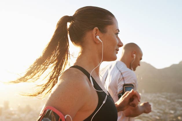 Getting into the running mood with some awesome tunes. a young couple exercising outdoors (License=RF) 20218723 ,model released, Symbolfoto  Copyright: xZoonar.com YurixArcursx 20218723 ,model released, Symbolfoto ,property released