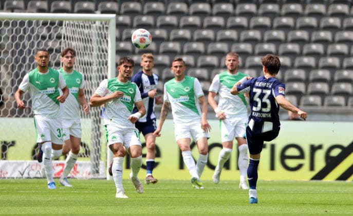 Michal Karbownik crosses the ball duel Match scene Action Sport Football Soccer DFL 2 Bundesliga Men 33 Matchday Season 2025 2026 10 05 2026 Hertha BSC Berlin vs SpVgg Greuther Fürth DFL regulations prohibit any use of photographs as image sequences and or quasi video