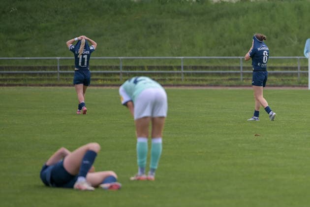 10 05 2026, Football, 2 Womens Bundesliga, 2025 2026, Matchday 25, SG 99 Andernach SC Sand Leni Fischer 11 Sand and Kim Schneider 8 Sand pull their shirts over their heads after the final whistle The draw feels like a defeat Andernach Stadium Rhineland-Palatinate Germany