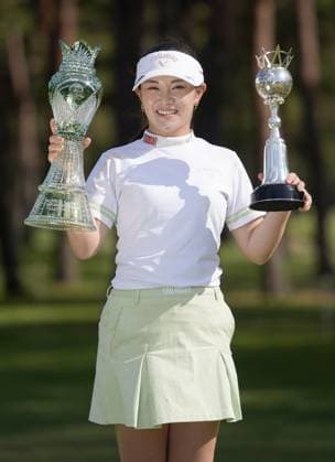 Golf: World Ladies Championship Salonpas Cup Yui Kawamoto smiles with trophies after winning the World Ladies Championship Salonpas Cup at Ibaraki Golf Club in Tsukubamirai in Ibaraki Prefecture, eastern Japan, on May 10, 2026.  A14AA0005540776P