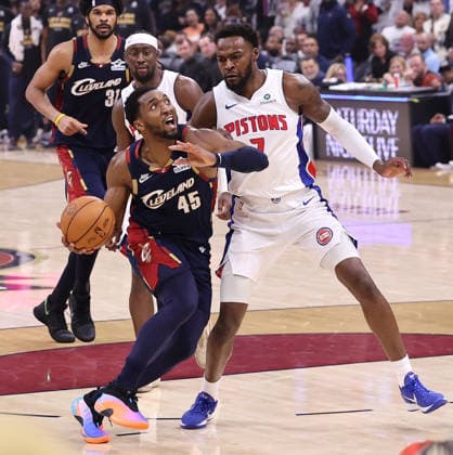 Cleveland Cavaliers Donovan Mitchell (45) drives to the basket while defended by Detroit Pistons Paul Reed (7) in the fourth quarter in Cleveland, Ohio Monday May 11, 2026. The Cavaliers defeated the Pistons 112-103 to tie the series at 2 games each.  CLE20260511111 AARONxJOSEFCZYK