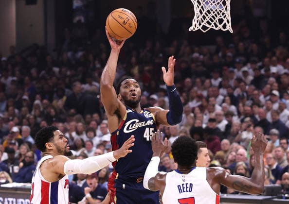Cleveland Cavaliers Donovan Mitchell (45) shoots over Detroit Pistons Tobias Harris (12) and Paul Reed (7) in the fourth quarter in Cleveland, Ohio Monday May 11, 2026. The Cavaliers defeated the Pistons 112-103 to tie the series at 2 games each.  CLE20260511114 AARONxJOSEFCZYK
