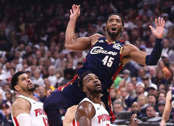 Cleveland Cavaliers Donovan Mitchell (45) watches his shot go in over Detroit Pistons Tobias Harris (12) and Paul Reed (7) in the fourth quarter in Cleveland, Ohio Monday May 11, 2026. The Cavaliers defeated the Pistons 112-103 to tie the series at 2 games each.  CLE20260511115 AARONxJOSEFCZYK