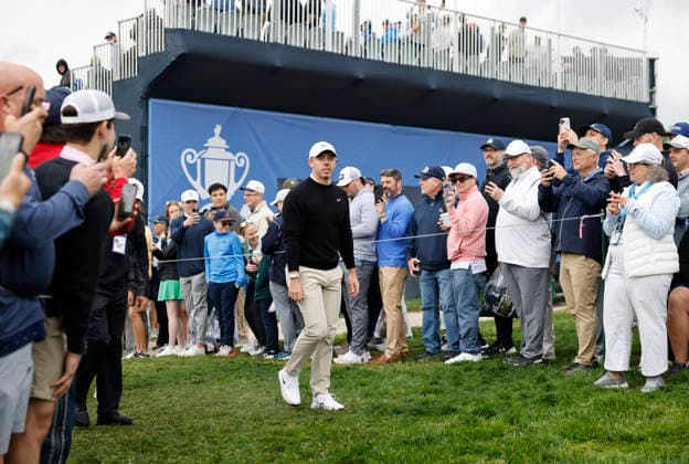 Rory McIlroy of Northern Ireland walks past spectators as he prepares to tee off on the 11th hole during the first round of the 2026 PGA, Golf Herren Championship at Aronimink Golf Club in Newtown Square, Pennsylvania, on Thursday, May 14, 2026.  PHI20260514833 LAURENCExKESTERSON