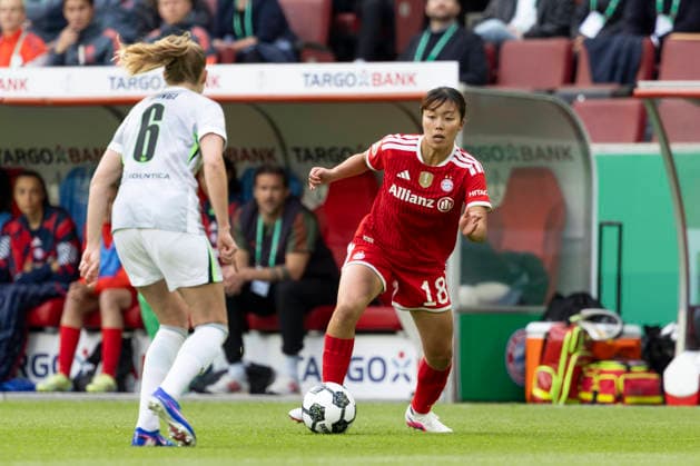 Momoko TANIKAWA M 18, right on the ball in a duel against Janina MINGE WOB 6, left , action DFB Pokal der Frauen Finale 2026, VfL Wolfsburg WOB FC Bayern Muenchen M , final score 0 4, am 14 05 2026 in Koeln Germany DFB regulations prohibit any use of photographs as image sequences and or quasi video Â