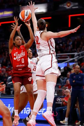 INDIANAPOLIS, IN - MAY 15: Indiana Fever guard Kelsey Mitchell (0) fires up her jump shot over Washington Mystics forward Angela Dugalic (32) during a WNBA, Basketball Damen, USA game between the Washington Mystics and Indiana Fever on May 15 2026 at Gainbridge Fieldhouse in Indianapolis, IN. (Photo by Jeffrey Brown Icon Sportswire) WNBA: MAY 15 Washington Mystics at Indiana Fever EDITORIAL USE ONLY Icon051526008