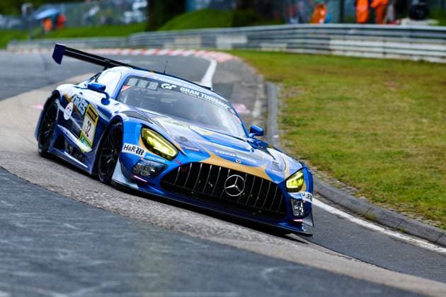 The Mercedes AMG GT3 with starting number 32 of the Toyo Tires with Ring Racing team drives through a bend on the Nürburgring The blue and gold car of Andreas Gülden Tim Sandtler Yuichi Nakayama Toyo Tires with Ring Racing bears the sponsors Toyo Tires, H R and Gran Turismo prominently on the bodywork The bright yellow headlights and the dynamic downforce rear wing underline the racing character of the GT3 car at the ADAC RAVENOL 24h Nürburgring 2026 Mercedes AMG GT3 32 from Toyo Tires with Ring Racing on the Nordschleife Copyright: xspeedshotx