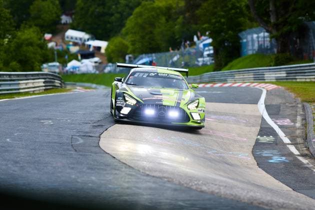 The Mercedes AMG GT3 with starting number 80 of the Mercedes AMG Team RAVENOL team drives through a tight bend on the Nordschleife of the Nürburgring with its headlights switched on The striking green and black painted car Fabian Schiller Luca Stolz Maro Engel Maxime Martin Mercedes AMG Team RAVENOL carries sponsors such as RAVENOL, Gran Turismo, H R and Goodyear and is dynamically staged in front of the typical track panorama of the Eifel Mercedes AMG GT3 80 of Mercedes AMG Team RAVENOL on the Nordschleife Copyright: xspeedshotx