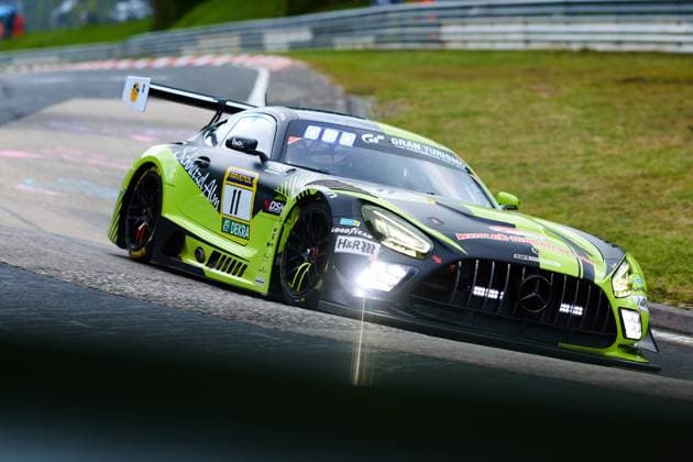 The Mercedes AMG GT3 with starting number 11 from SR Motorsport by Schnitzelalm drives through a bend on the Nordschleife of the Nürburgring The black and neon green vehicle Jannes Fittje Jay Mo Härtling Kenneth Heyer Philip Ellis SR Motorsport by Schnitzelalm is decorated with sponsors such as RAVENOL, Goodyear and H R and shows the typical curb limitation of the legendary track Mercedes AMG GT3 11 from SR Motorsport by Schnitzelalm on the Nordschleife in a dynamic driving moment Copyright: xspeedshotx