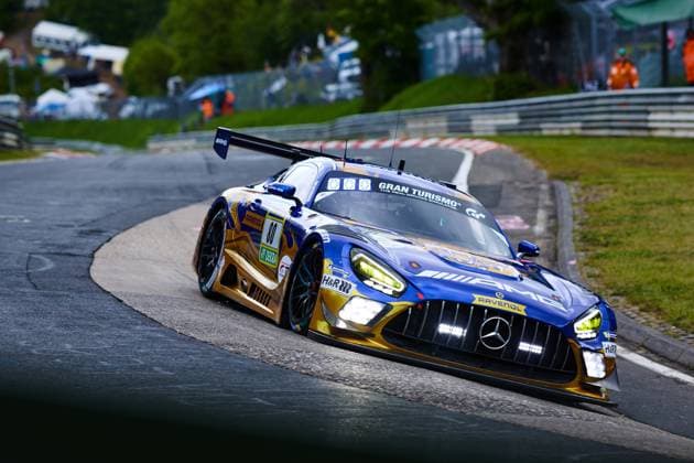 The Mercedes AMG GT3 with starting number 80 of the Mercedes AMG Team RAVENOL drives through a tight bend on the Nordschleife of the Nürburgring The vehicle in the characteristic blue and gold design with RAVENOL and Gran Turismo sponsoring is low in the bend, the headlights shine brightly Sponsors such as H R and DEKRA are clearly recognizable on the bodywork Fabian Schiller Luca Stolz Maro Engel Maxime Martin Mercedes AMG Team RAVENOL Mercedes AMG GT3 80 by RAVENOL in the bend at the Nürburgring Copyright: xspeedshotx