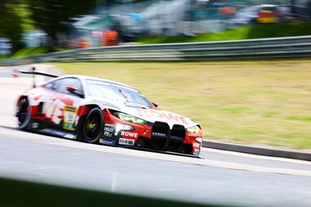 The BMW M4 GT3 from ROWE RACING with the starting number 99 drives at high speed through a section of the Nordschleife at the Nürburgring The vehicle in the striking red and white ROWE livery is equipped with sponsors such as H R, Michelin, Synopsys and Endless The panning shot underlines the dynamics of the racing car at the ADAC RAVENOL 24h Nürburgring 2026 ROWE RACING BMW M4 GT3 99 on the Nordschleife Copyright: xspeedshotx
