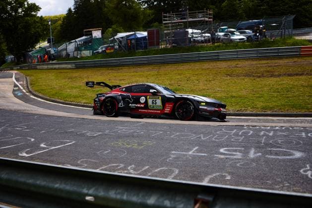 The Ford Mustang GT3 Colin Caresani David Schumacher Hubert Haupt Vincent Kolb HRT Ford Racing by HRT Ford Racing drives through a bend at the Nürburgring The black and red car with starting number 65 bears the sponsors ADVAN, RAVENOL and DEKRA and is adorned with Ford Racing logos In the background, grandstands, barriers and spectators can be seen, underlining the iconic atmosphere of the 24-hour race Ford Mustang GT3 65 by HRT Ford Racing in the bend at the Nürburgring Copyright: xspeedshotx