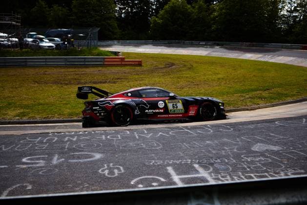The Ford Mustang GT3 with the starting number 65 of the HRT Ford Racing team drives through a curve on the Nürburgring The black and red vehicle bears prominent sponsor logos of ADVAN Yokohama and Ford Racing on the flank The typical orange curbs and the wooded landscape of the Eifel can be seen in the background Colin Caresani David Schumacher Hubert Haupt Vincent Kolb HRT Ford Racing Ford Mustang GT3 65 from HRT Ford Racing on the Nürburgring Copyright: xspeedshotx