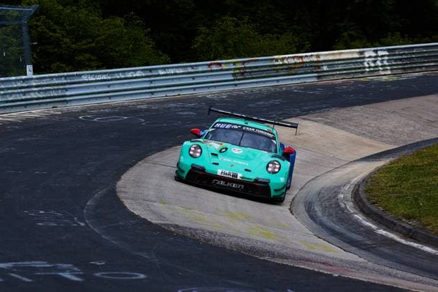 The turquoise-colored Porsche 911 GT3 R from Falken Motorsports with the starting number 44 drives through a tight curve on the Nordschleife of the Nürburgring The vehicle wears the distinctive Falken tires and is decorated with sponsors such as H R and Gran Turismo Klaus Bachler Morris Schuring Sven Müller Tim Heinemann Falken Motorsports Falken Porsche 911 GT3 R drives through a tight curve on the Nordschleife Copyright: xspeedshotx
