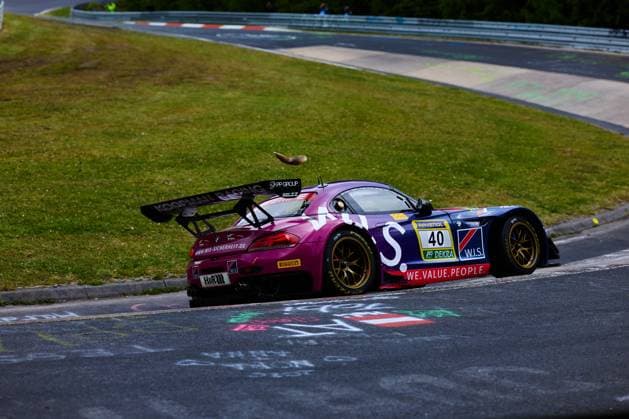 The BMW M6 GT3 with starting number 40 of the W I S Racing Team powered by Koopman Racing team drives through a bend on the Nordschleife at the Nürburgring The purple and dark blue vehicle bears the sponsors RAVENOL, DEKRA, W I S, H R and Pirelli A squirrel can be seen on the vehicle, The car shows a squirrel apparently jumping over the roof of the racing car - an unusual moment in racing Frank Nikolaus Michael Funke Peter Posavac Volker Strycek W I S Racing Team powered by Koopman Racing BMW M6 GT3 40 from W I S Racing on the Nordschleife Copyright: xspeedshotx