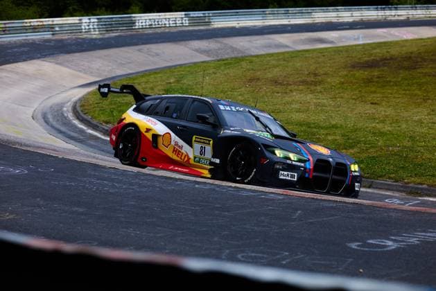 The BMW M3 GT with starting number 81 from the Schubert Motorsport team negotiates a tight bend on the Nordschleife at the Nürburgring The vehicle features the distinctive Shell Helix livery in black, red and yellow with the characteristic BMW M stripes Sponsors such as Shell, RAVENOL, H R and Bosch are clearly visible on the bodywork Connor de Phillippi Jens Klingmann Neil Verhagen Ugo de Wilde BMW M Motorsport BMW M3 GT 81 from Schubert Motorsport on the Nordschleife bend Copyright: xspeedshotx