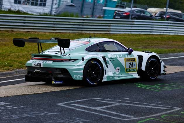 The Porsche 911 GT3 R with starting number 24 from Lionspeed GP Laurens Vanthoor Laurin Heinrich Ricardo Feller Lionspeed GP drives through a bend at the Nürburgring The vehicle has a striking mint green design with white accents and the main sponsor TENTLA Other sponsors such as RAVENOL, DEKRA, H R and Michelin are clearly visible on the bodywork Porsche 911 GT3 R 24 from Lionspeed GP at the Nürburgring Copyright: xspeedshotx