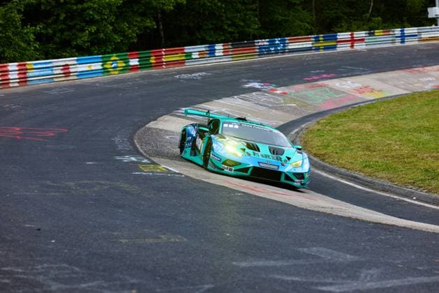 The turquoise Lamborghini Huracán GT3 with the starting number 91 from Reiter Engineering drives through a tight curve on the Nordschleife of the Nürburgring The vehicle with the sponsors H R and MEYLE can be seen in a dynamic curve, while in the background the typical colorful guardrails of the Nordschleife and dense trees characterize the picture Lukas Ertl Matthias Benndorf Maximilian Johannes Ertl Stefan Ertl Reiter Engineering Lamborghini Huracán GT3 91 from Reiter Engineering in the Nordschleife curve Copyright: xspeedshotx