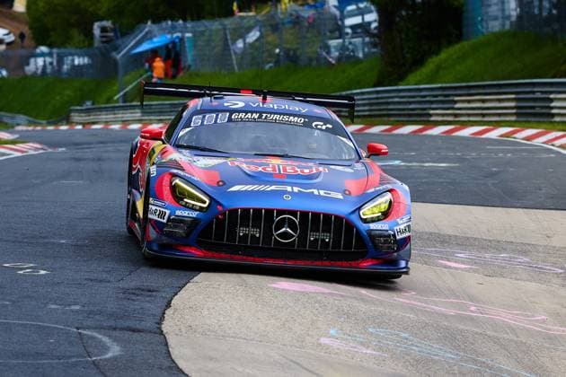 The Mercedes AMG GT3 with the starting number 3 of the Mercedes AMG Team Verstappen Racing drives through a curve on the Nordschleife at the Nürburgring The vehicle Daniel Juncadella Jules Gounon Lucas Auer Max Verstappen Mercedes AMG Team Verstappen Racing wears the striking Red Bull livery in blue, red and gold and is prominently adorned with sponsors such as Viaplay, Gran Turismo and AMG The yellow headlights and the large rear wing emphasize the GT3 racing character of the Mercedes AMG GT3 3 vehicle from Verstappen Racing on the Nordschleife Copyright: xspeedshotx