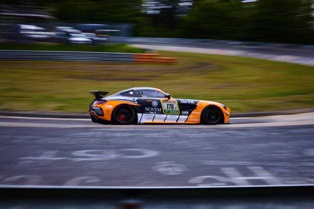 The Mercedes AMG GT3 with the starting number 176 from PROsport Racing drives through a corner at high speed on the Nürburgring The eye-catching orange and black and white vehicle Abée Anton Guilherme de Oliveira Jörg Viebahn LLuc Ibanez Yannik Himmels PROsport Racing carries the sponsors NOVEM Gold, RAVENOL, Dorint and DEKRA on the livery The panning shot emphasizes the dynamics and speed of the car during the ADAC RAVENOL 24h Nürburgring 2026 Mercedes AMG GT3 176 of PROsport Racing at the Nürburgring Copyright: xspeedshotx