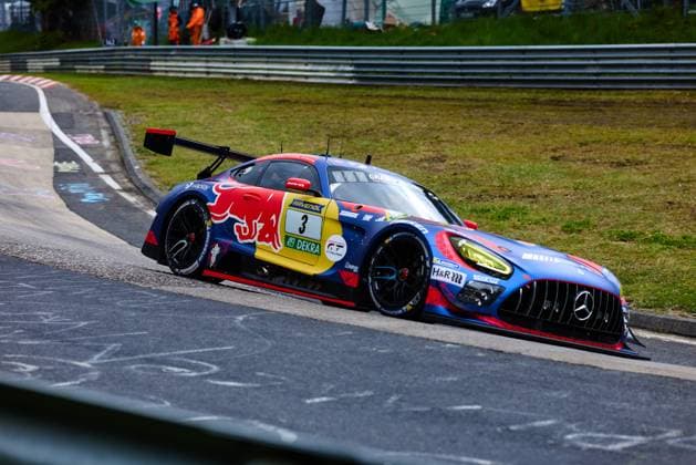 The Mercedes AMG GT3 with starting number 3 of Mercedes AMG Team Verstappen Racing takes a tight corner on the Nordschleife at the Nürburgring The vehicle wears a striking Red Bull livery in blue and red with RAVENOL and DEKRA sponsorship Daniel Juncadella Jules Gounon Lucas Auer Max Verstappen Mercedes AMG Team Verstappen Racing confidently negotiates the corner exit on the characteristic asphalt of the Nordschleife Mercedes AMG GT3 3 from Verstappen Racing on the Nordschleife Copyright: xspeedshotx
