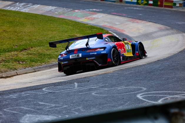 The Mercedes AMG GT3 with the starting number 3 of the Mercedes AMG Team Verstappen Racing drives through a corner on the Nordschleife at the Nürburgring The blue car of Daniel Juncadella Jules Gounon Lucas Auer Max Verstappen Mercedes AMG Team Verstappen Racing is decorated with the sponsors Red Bull, H R and Michelin and shows the typical GT3 aerodynamics with a striking rear section and large rear wing Characteristic chalk markings of the fans can be seen on the kerb and the track surface Mercedes AMG GT3 3 by Verstappen Racing on the Nordschleife Copyright: xspeedshotx