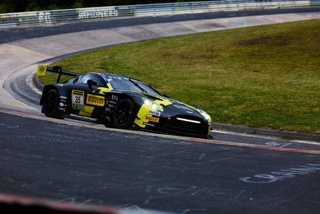 The Aston Martin GT3 with the starting number 35 from Walkenhorst Motorsport drives through a corner on the Nordschleife of the Nürburgring The black and yellow car Dennis Fetzer Felipe Fernandez Laser Mateo Villagoméz Stefan Aust Walkenhorst Motorsport is equipped with sponsors such as RAVENOL, Pirelli, DEKRA and H R and shows the characteristic AMR logos The typical green areas and curbs of the Nordschleife can be seen in the background Aston Martin 35 from Walkenhorst Motorsport on the Nordschleife Copyright: xspeedshotx