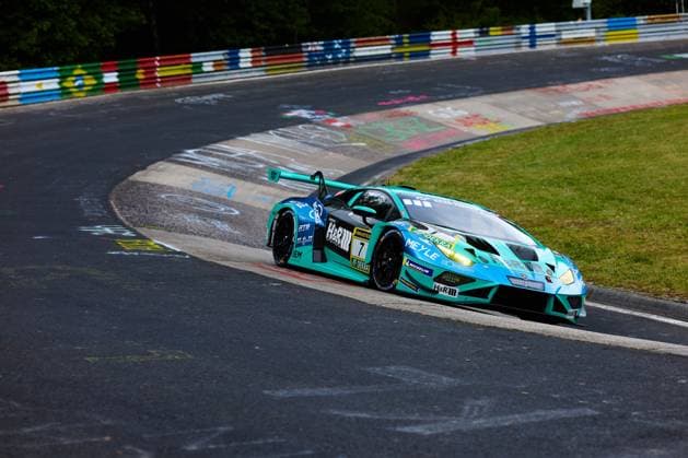 The Lamborghini Huracán GT3 with starting number 7 from Konrad Motorsport drives through a tight corner on the Nordschleife of the Nürburgring The turquoise and black car Christian Engelhart Maximilian Paul Patricija Stalidzane Pavel Lefterov Konrad Motorsport carries sponsors such as H R, RAVENOL, MEYLE and Michelin and shows the characteristic colorful catch fences of the Nordschleife in the background Lamborghini Huracán GT3 7 from Konrad Motorsport on the Nordschleife Copyright: xspeedshotx