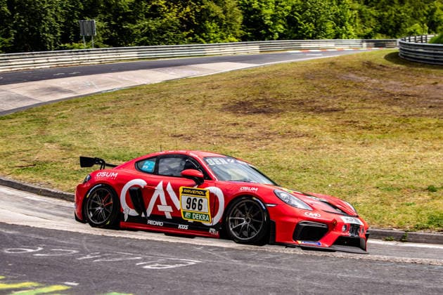 A red Porsche 911 GT3 R Evo takes a bend on the Nürburgring racetrack in Rhineland-Palatinate Germany