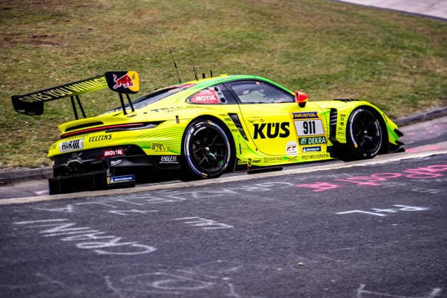 Manthey 911 SP 9 The yellow-green Porsche 911 GT3 R 911 with sponsors such as KÜS and Ravenol drives on the Nürburgring racetrack in Rhineland-Palatinate Germany