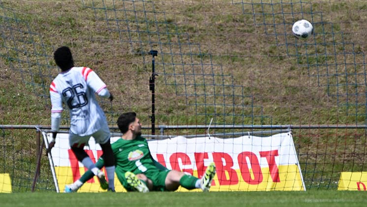 Soccer Regionalliga Nordost, Season 2025 2026, Matchday 34, FC Eilenburg vs Hallescher FC 16 05 2026 Goal for HFC in match Eilenburg vs Halle 16 05 2026 Goalscorer Bocar Baro Attack Storm Hallescher FC, back number 26 re scores against Niclas Ben Edelmann Goalkeeper Eilenburg, back number 1 center to 0 2 Eilenburg Saxony Germany Ilburg Stadium