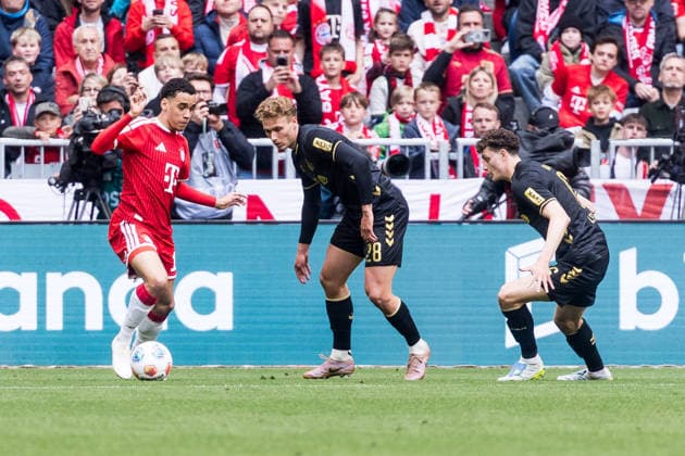 MUNICH, GERMANY - MAY 16: Jamal Musiala (FC Bayern Muenchen, 10) controls the ball against Sebastian Sebulonsen (1. FC Koeln, 28) and Eric Martel (1. FC Koeln, 6) during the Bundesliga match between FC Bayern Muenchen vs. 1. FC Koeln at Allianz Arena on matchday 34 of the 1. Bundesliga on May 16, 2026 in Munich, Germany. DFL REGULATIONS PROHIBIT ANY USE OF PHOTOGRAPHS AS IMAGE SEQUENCES AND OR QUASI-VIDEO. Bavaria Germany Copyright: xSteffiexWunderlx