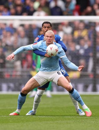 London, England, 16th May 2026. Erling Haaland of Manchester City held up by Levi Colwill of Chelsea during the Chelsea vs Manchester City FA Cup Final match at Wembley Stadium, London. Picture credit should read: David Klein Sportimage EDITORIAL USE ONLY. No use with unauthorised audio, video, data, fixture lists, club league logos or live services. Online in-match use limited to 120 images, no video emulation. No use in betting, games or single club league player publications. SPI_040_DK_Chelsea_Manchester_City SPI-4803-0041