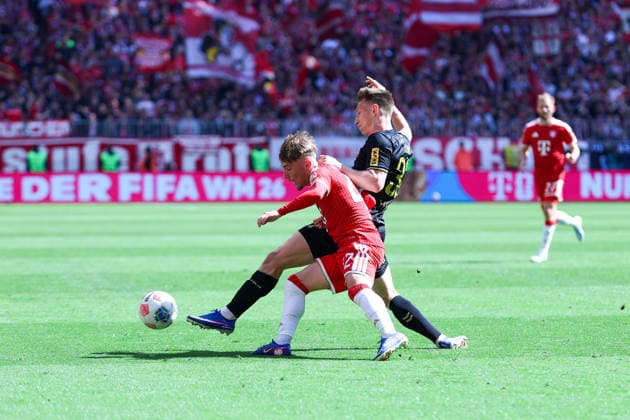 GER 1 FBL, FC Bayern München vs 1 FC Köln 16 05 2026, Allianz Arena, Munich, GER 1 FBL, FC Bayern München vs 1 FC Köln, picture shows Lennart Karl FC Bayern München 42 , left Kristoffer Lund 1 FC Köln 32 , right nordphotoxGmbHx xSchneider nph00003