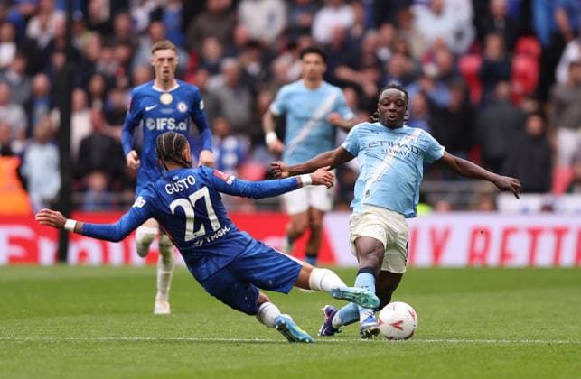 London, England, 16th May 2026. Malo Gusto of Chelsea lunges into Jeremy Doku of Manchester City during the Chelsea vs Manchester City FA Cup Final match at Wembley Stadium, London. Picture credit should read: David Klein Sportimage EDITORIAL USE ONLY. No use with unauthorised audio, video, data, fixture lists, club league logos or live services. Online in-match use limited to 120 images, no video emulation. No use in betting, games or single club league player publications. SPI_075_DK_Chelsea_Manchester_City SPI-4803-0076