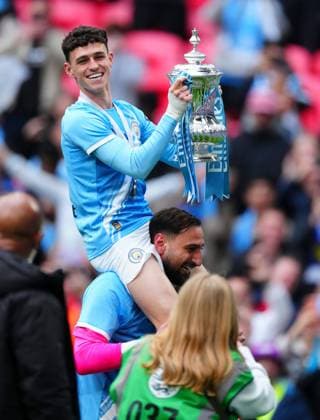 Phil Foden celebrates with the trophy on the shoulders of Manchester City goalkeeper Gianluigi Donnarumma Chelsea v Manchester City, Emirates FA Cup Final, Football, Wembley Stadium, London, UK - 16 May 2026London Wembley Stadium United Kingdom EDITORIAL USE ONLY No use with unauthorised audio, video, data, fixture lists, club league logos or live services. Online in-match use limited to 120 images, no video emulation. No use in betting, games or single club league player publications.  Copyright: xJavierxGarcia Shutterstockx 16876844ca