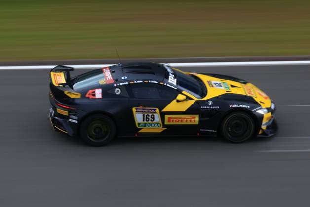 Heiko Hahn Philippe Charlaix Roland Waschkau Peter Sander Doerr Motorsport from Doerr Motorsport races around the Nürburgring at high speed The black and yellow vehicle, an Aston Martin GT4, bears the starting number 169 and is decorated with sponsors such as Pirelli, Falken, RAVENOL and DEKRA The panning shot emphasizes the dynamics of the racing car on the track Aston Martin 169 from Doerr Motorsport at the Nürburgring Copyright: xspeedshotx