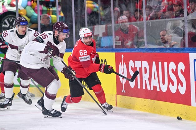 ZURICH, SWITZERLAND MAY 16 Oskars Batna of Latvia L and Denis Malgin of Switzerland R chase the puck during the 2026 IIHF Ice Hockey World Championship Switzerland game between Switzerland and Latvia at Swiss Life Arena on May 16, 2026 in Zurich, Zurich Zurich Swiss Life Arena Zurich Switzerland Copyright: xJustPictures.ch AndreaxBrancax jp-en-EuSpIm-JP7_ANB_Sui_Lat_16052026_3694
