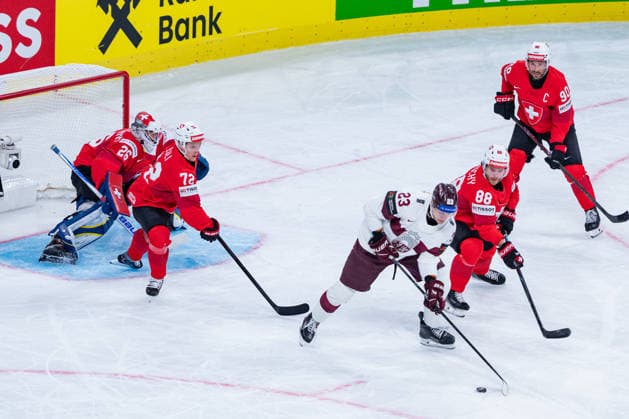 ZURICH, SWITZERLAND - MAY 16: Sandis Villains (Latvia, 23) in front of the Goal of Sandro Aeschlimann (Switzerland, 26) fighting against Christoph Bertschy (Switzerland, 88) and Dominik Egli (Switzerland, 72) during the Preliminary Round - Group A Match 9 between Switzerland and Latvia at the IIHF Ice hockey, Eishockey World Championship, WM, Weltmeisterschaft 2026, Swiss Life Arena on May 16, 2026 in Zurich, Switzerland. Zurich Switzerland Copyright: xTimoxSteinx
