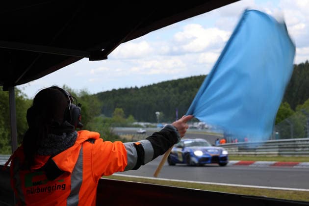 Nürburg, Germany 14 17 May 2026 ADAC Ravenol 24h Race Nürburgring 2026 Saturday Race Swallowtail In the picture Marshal, Blue Flag, Waving, Nürburgring Rheinland Pfalz Copyright: xFotostandx xFabianxWernerx