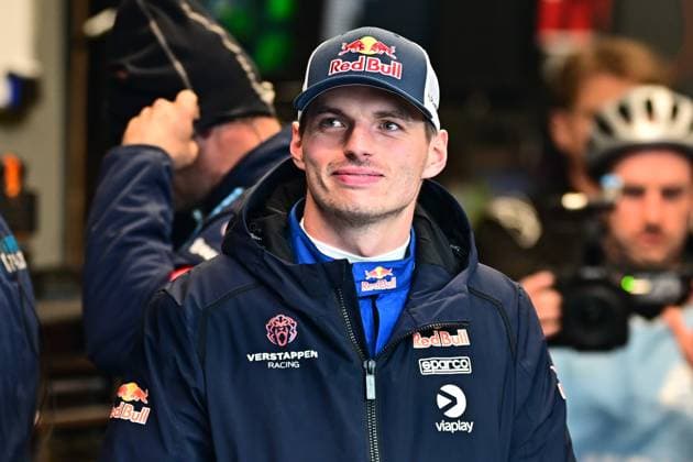Max Verstappen can be seen in the paddock of the Nürburgring He wears the team clothing of Mercedes AMG Team Verstappen Racing with Red Bull, Sparco and Viaplay logos Other team members and cameramen can be seen in the background Max Verstappen in the paddock at the 24h Nürburgring 2026 Copyright: xMichaelxGelhardtx