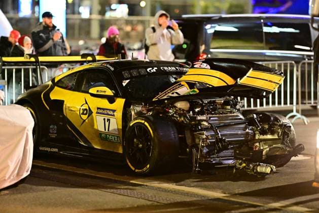 The Alessio Picariello Dorian Boccolacci Julien Andlauer Nico Menzel Dunlop Motorsport from Dunlop Motorsport is standing after a serious accident at the Nürburgring The entire front of the black and yellow GT3 car is completely torn off - the engine, drivetrain and chassis components lie exposed on the asphalt The hood is open, the rear wing is also damaged Sponsors such as RAVENOL, DEKRA and Gran Turismo are visible on the bodywork Numerous spectators in the background watch and photograph the accident scene at night Heavily damaged 17 Dunlop Motorsport GT3 at the Nürburgring Copyright: xMichaelxGelhardtx
