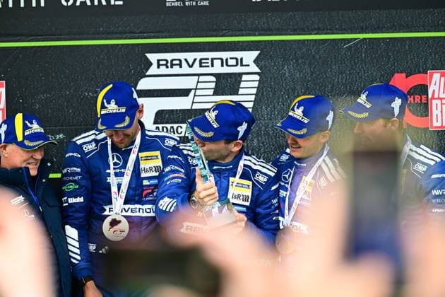 The victorious team Mercedes AMG Team RAVENOL with starting number 80 celebrates its victory on the podium of the 24h Nürburgring The drivers in the characteristic blue racing overalls with Michelin helmets and RAVENOL branding hold their medals and celebrate the long-distance success Mercedes AMG GT3 80 from Mercedes AMG Team RAVENOL on the podium at the Nürburgring Copyright: xMichaelxGelhardtx