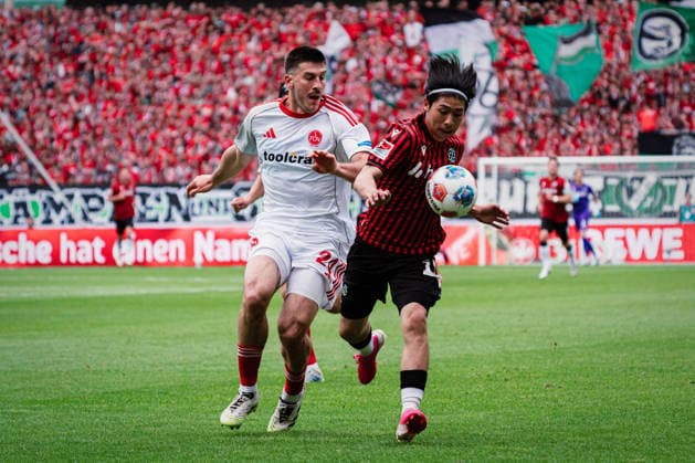 2 Bundesliga Hannover 96 vs 1 FC Nürnberg, 17 05 2026 Luka Lochoshvili 1 FC Nürnberg, 24 vs Daisuke Yokota Hannover 96, 18 in duel Football, 2 Bundesliga, Matchday 34 Hannover 96 vs 1 FC Nürnberg on 17 05 2026 at Heinz von Heiden Arena, Hannover DFL REGULATIONS PROHIBIT ANY USE OF PHOTOGRAPHS AS IMAGE SEQUENCES AND OR QUASI VIDEO Copyright: xBEAUTIFULxSPORTS Tonhäuserx