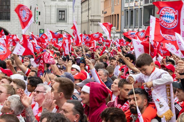 Fußball: Meisterfeier des FC Bayern München auf dem Rathausbalkon und am Marienplatz in München nach dem Gewinn der Bundesliga-Saison 2025 2026. Hunderte Fans auf dem Marienplatz in München mit Fahnen, Schals, Luftballons und Trikots mit Vereinslogo feiern
