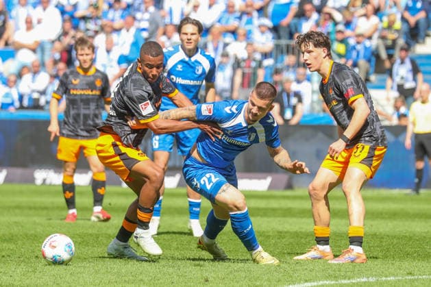 17 05 2026, xgox, Soccer 2 Bundesliga 1 FC Magdeburg 1 FC Kaiserslautern emspor, v l David Schramm Kaiserslautern, 41 , Mateusz Zukowski Magdeburg, 22 , Leon Robinson Kaiserslautern, 37 duel, fight, tackle DFL DFB REGULATIONS PROHIBIT ANY USE OF PHOTOGRAPHS as IMAGE SEQUENCES and or QUASI VIDEO Magdeburg