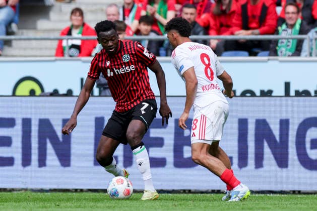 Mustapha Bundu Hannover 96 and Henri Koudossou 1 FC Nuernberg battle for the ball, 2 Bundesliga, Hannover 96 v 1 FC Nuernberg, Heinz von Heiden Arena on May 17, 2026 in Hanover, Germany Photo by Marco Steinbrenner DeFodi Images Mustapha Bundu Hannover 96 and Henri Koudossou 1 FC Nuernberg battle for the ball, 2 Bundesliga, Hannover 96 v 1 FC Nuernberg, Heinz von Heiden Arena, May 17, 2026 in Hanover, Germany Photo by Marco Steinbrenner DeFodi Images