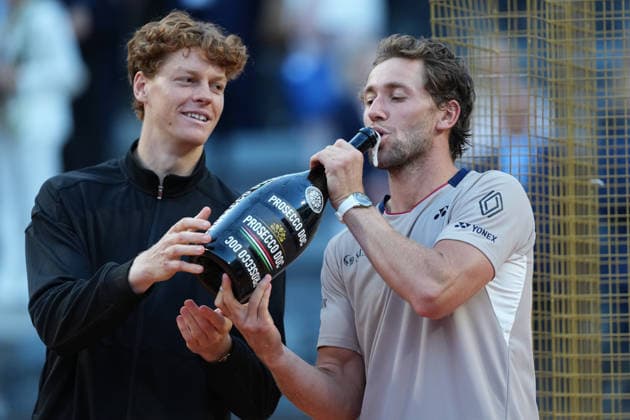 Casper Ruud of Norway drinks sparkling wine next to Jannik Sinner during the victory ceremony of the Internazionali BNL d Italia 2026 tennis tournament at Foro Italico in Rome (Italy) on May, 17, 2026. AntoniettaxBaldassarre